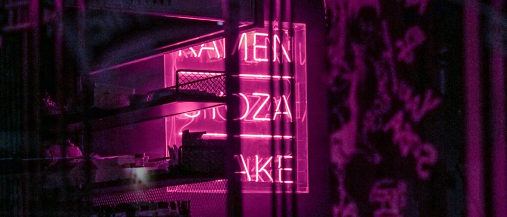 A neon sign is lit up in the dark